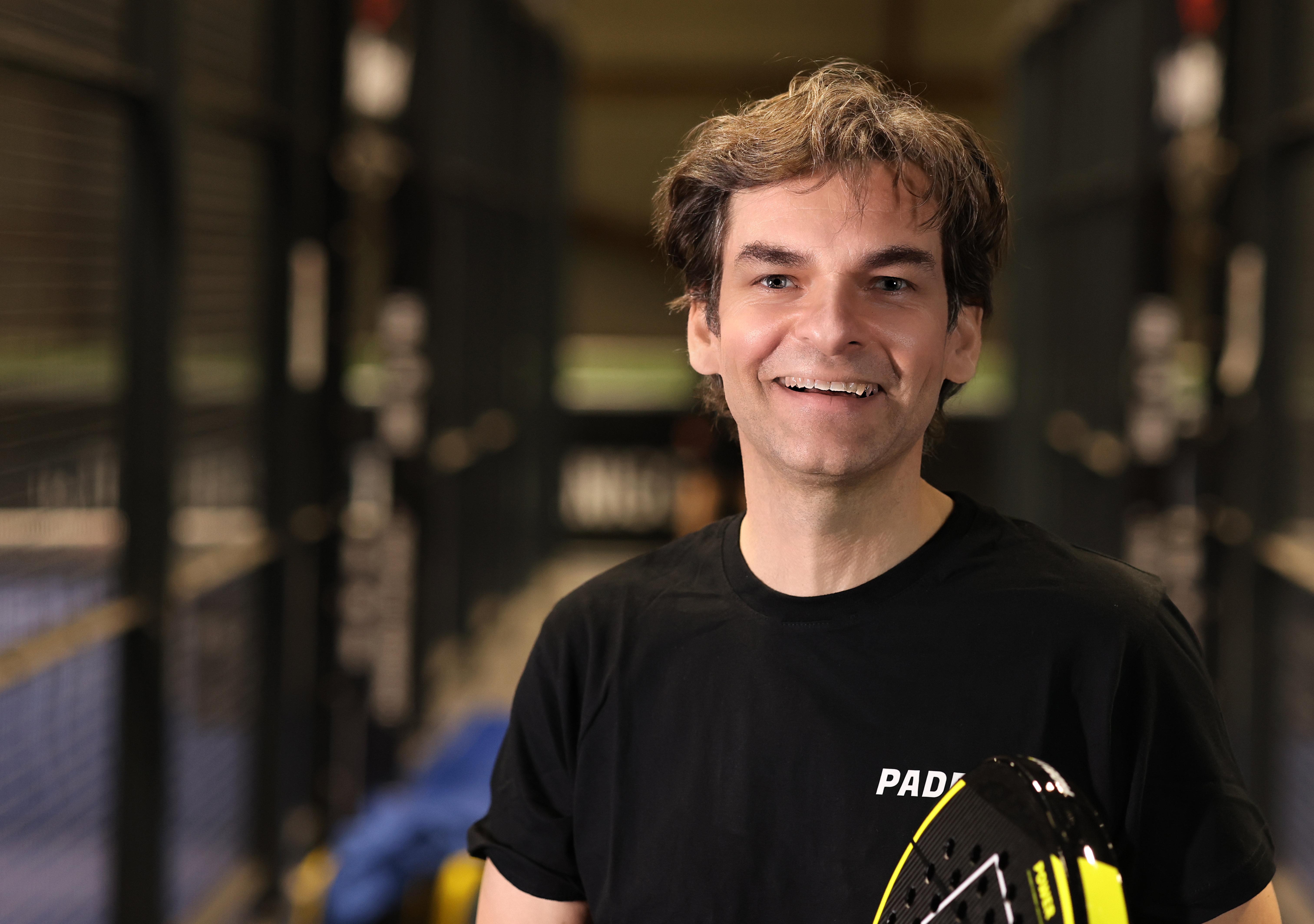 Whitney leaning against a railing on a downtown street